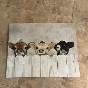 it is a sign with three baby cows and a baby duck on one of them